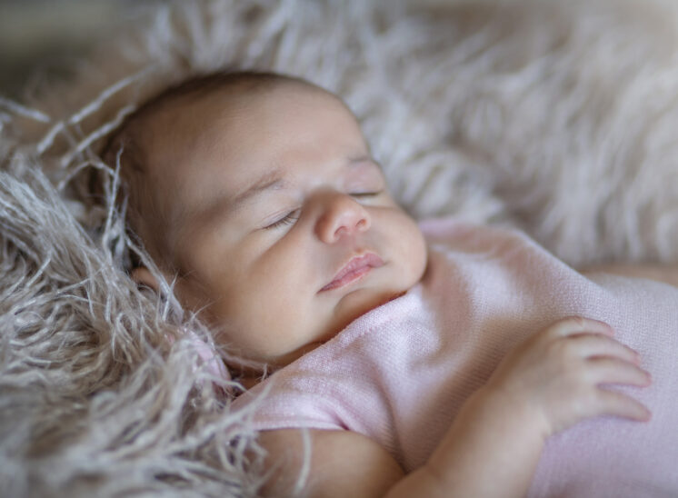 Baby girl naps during baby photos