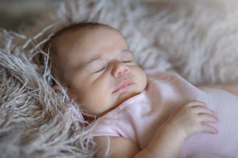 Baby girl naps during baby photos