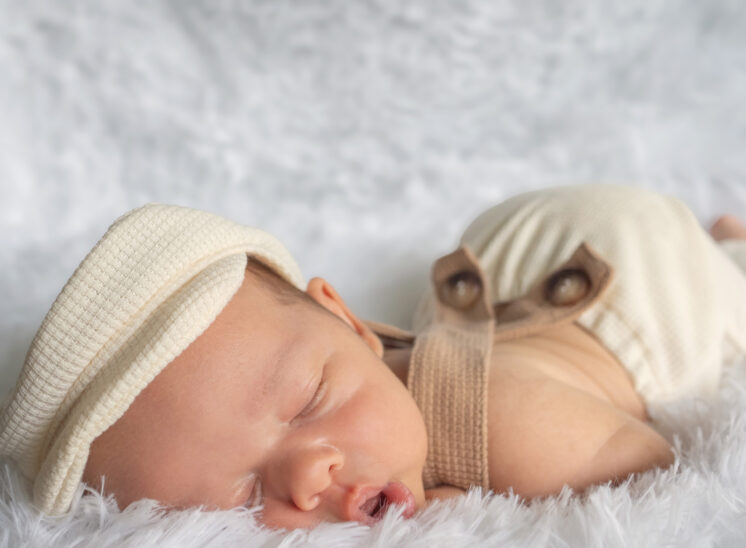 Baby in hat has butt in air