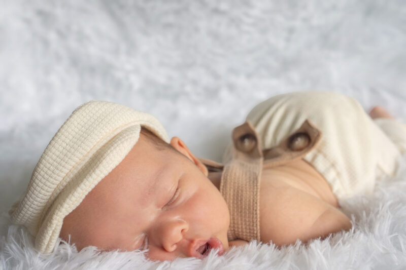 Baby in hat has butt in air