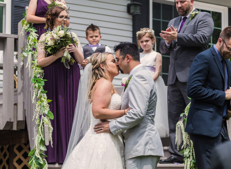 Couple kisses at end of wedding