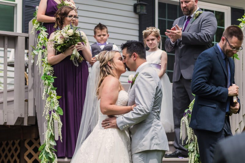 Couple kisses at end of wedding