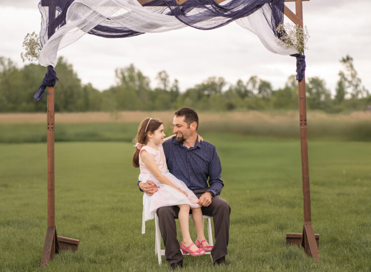 Dad and daughter sit before wedding