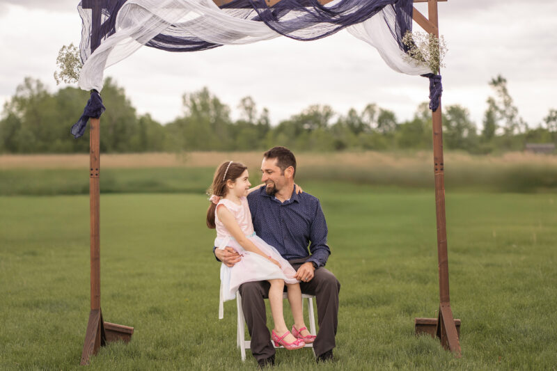 Dad and daughter sit before wedding