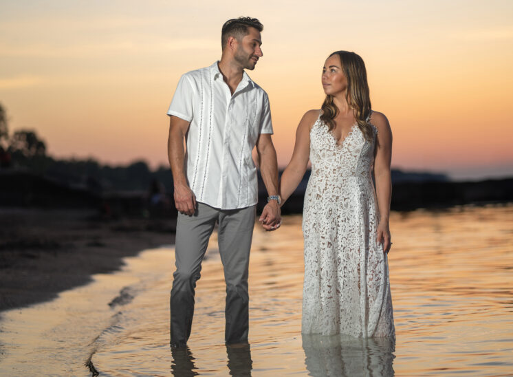 engaged couple walk during photoshoot