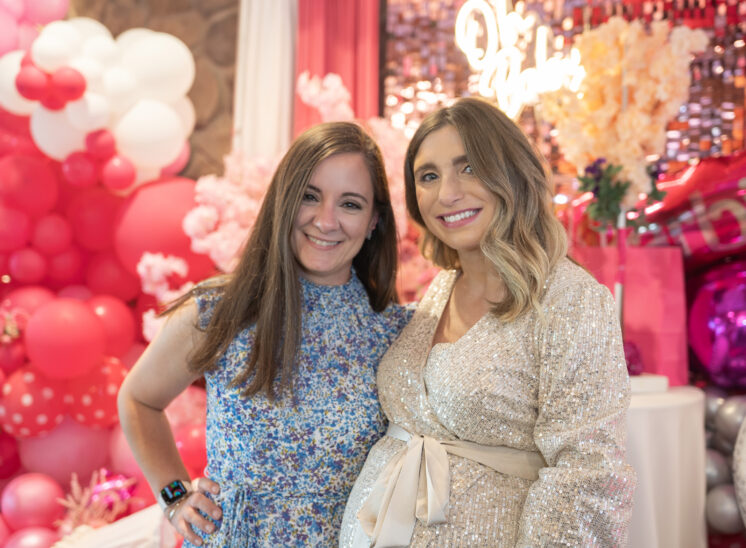 friends pose at baby shower