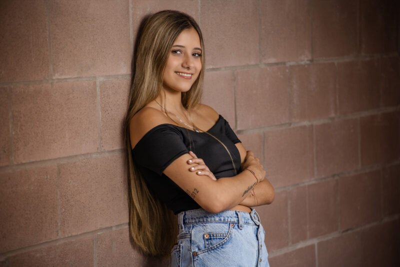girl poses for senior photo