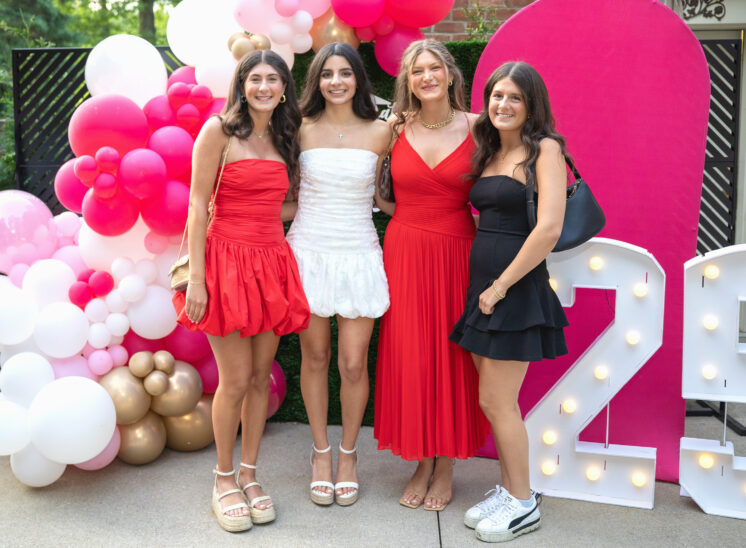 high school graduate poses with friends