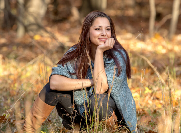 High school senior smiles in the woods