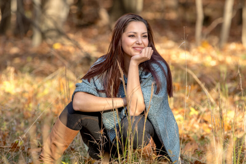 High school senior smiles in the woods