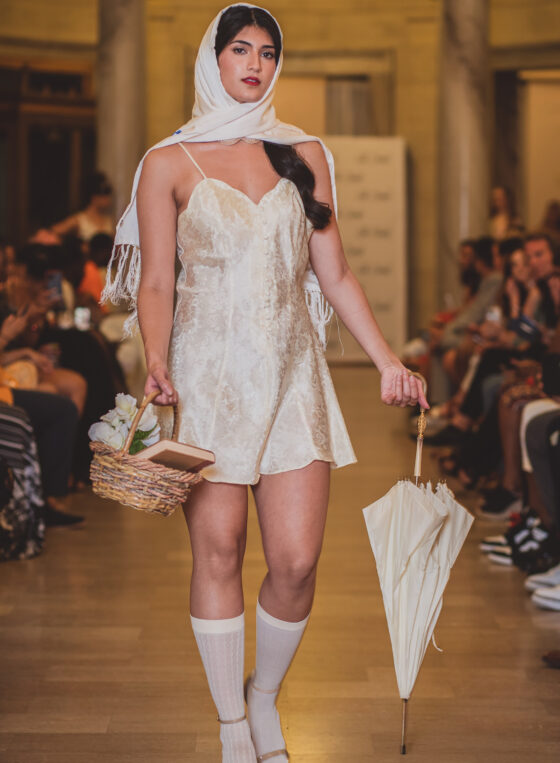 Model in head scarf poses on Cleveland runway