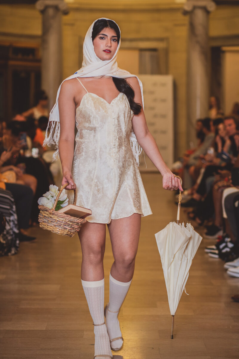 Model in head scarf poses on Cleveland runway