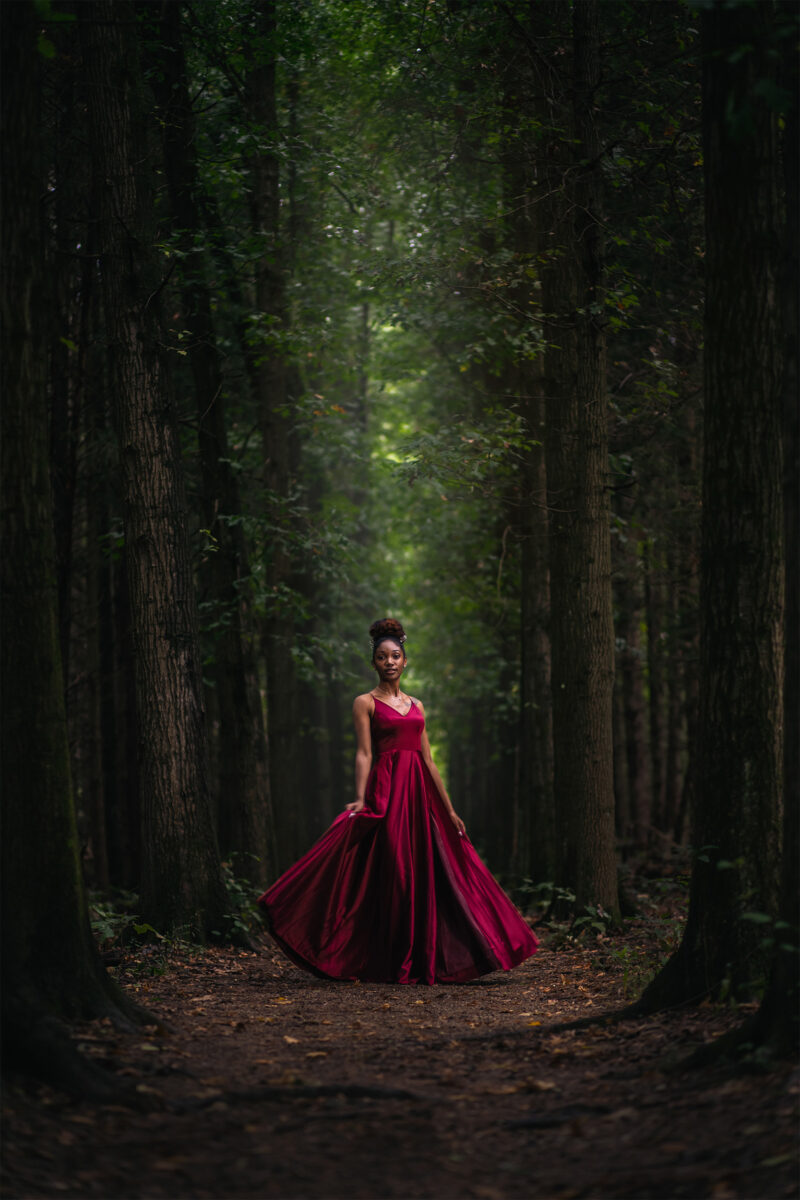 Model poses in pine trees