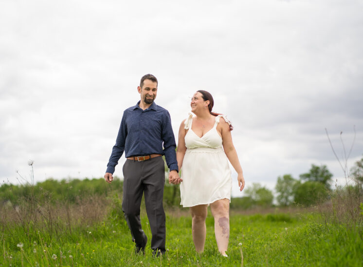 Newly married couple hold hands