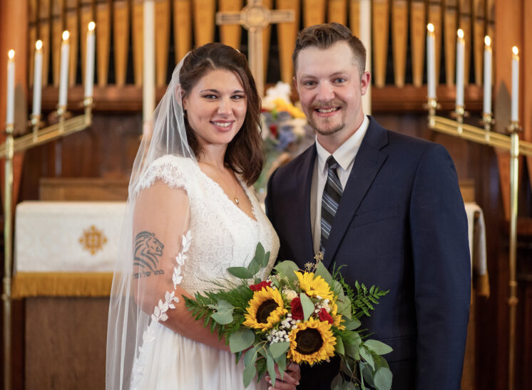 Newly-weds pose for wedding photo