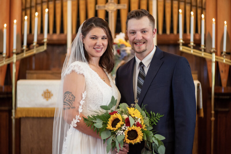 Newly-weds pose for wedding photo