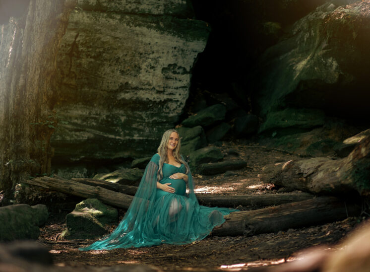 pregnant mother poses in woods