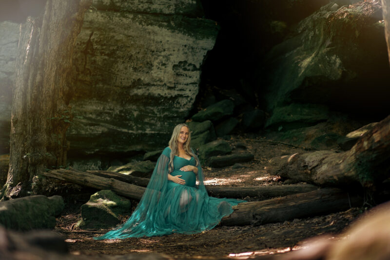 pregnant mother poses in woods