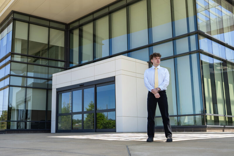senior poses at modern building
