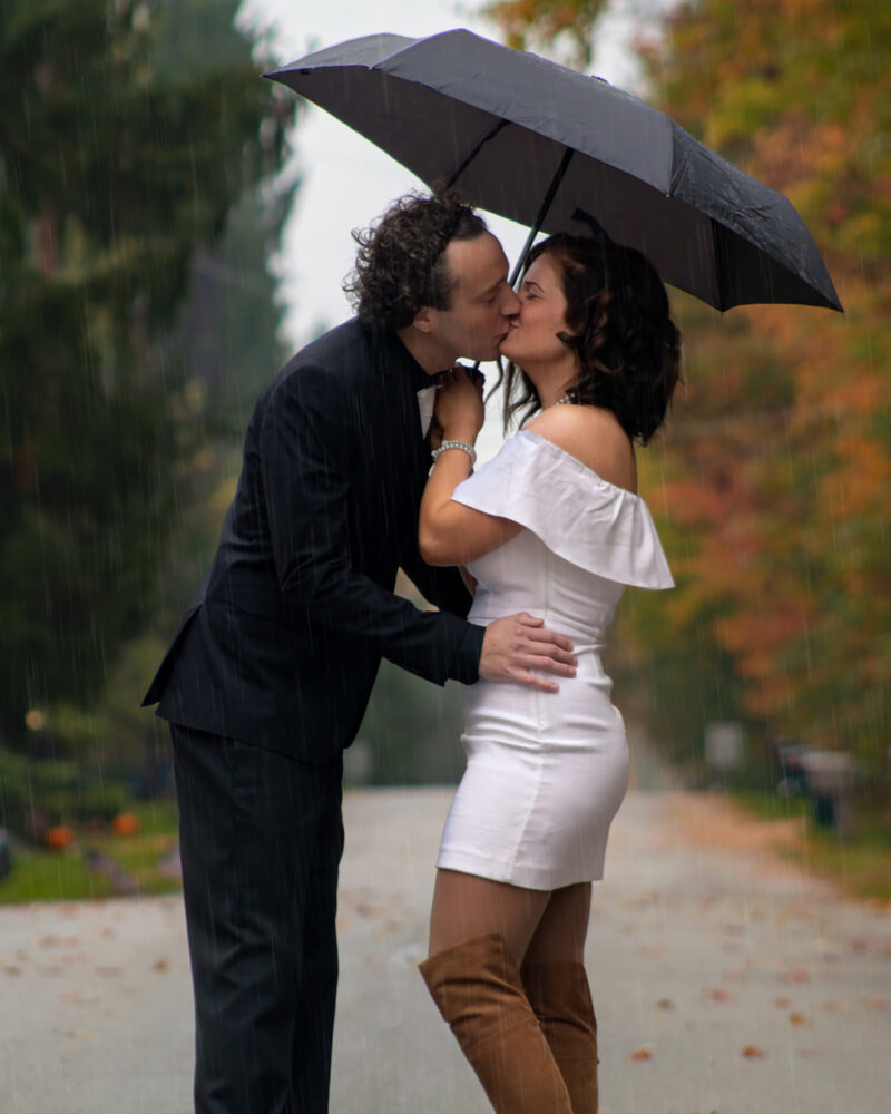 Wedding couple kiss in the rain