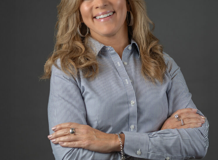 Woman crosses arms during headshots