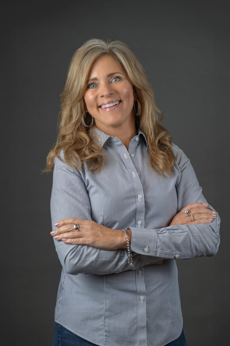 Woman crosses arms during headshots