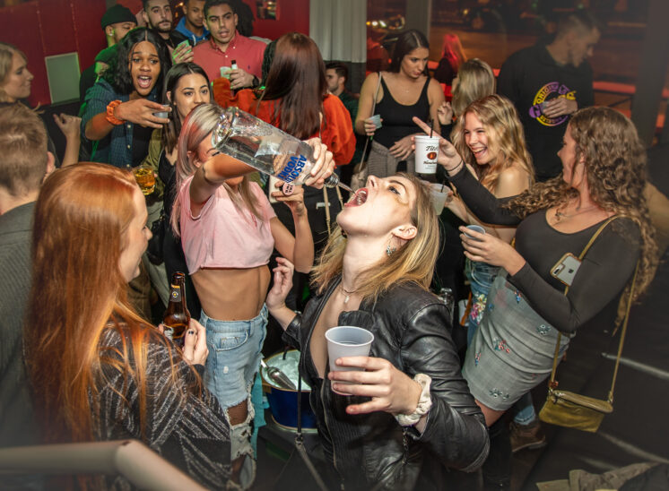 Woman pours vodka in friends mouth at Cleveland bar