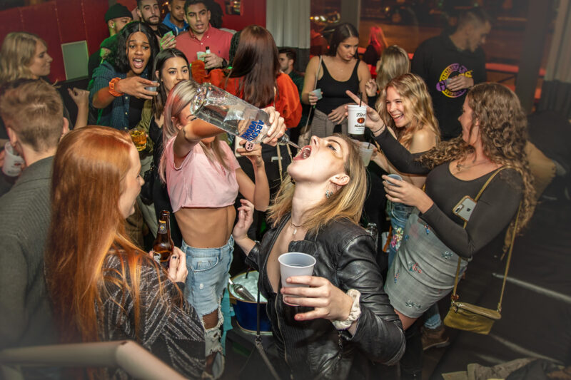 Woman pours vodka in friends mouth at Cleveland bar