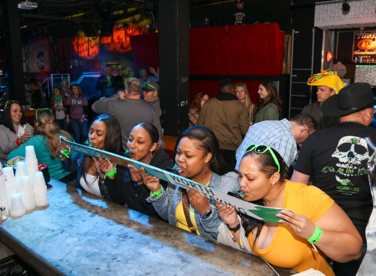 Women at bar crawl do a shotski