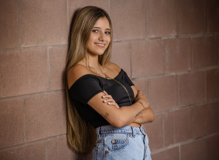 Senior crosses arms during photo shoot