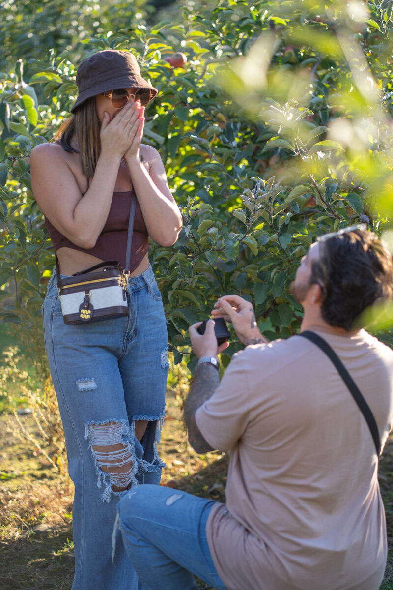 Man on one knee during surprise proposal