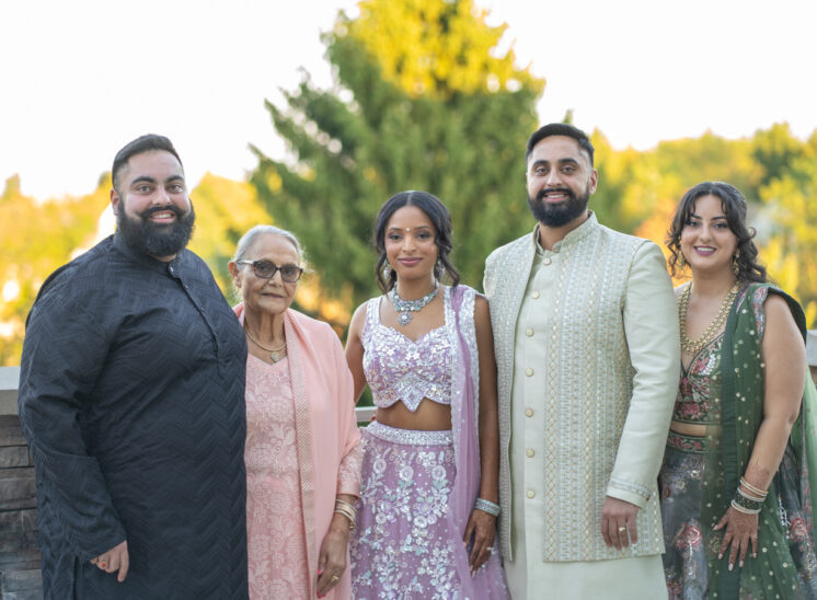 New bride and groom pose with family