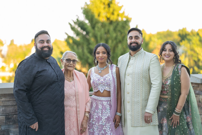 New bride and groom pose with family