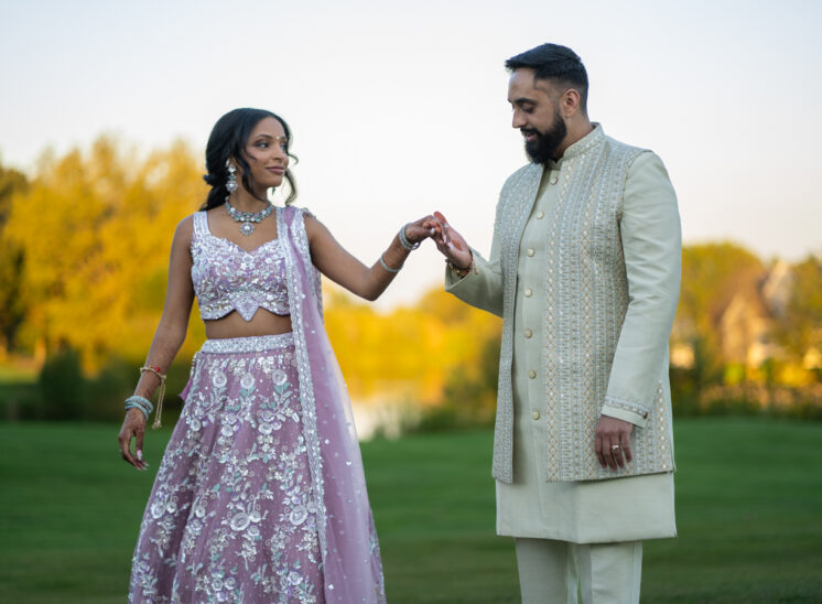 Newlyeweds hold hands during wedding reception