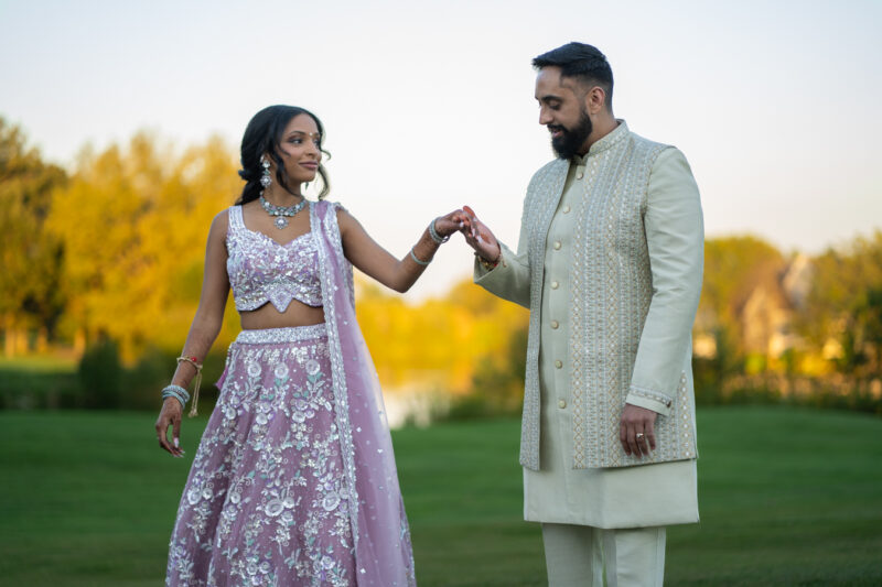 Newlyeweds hold hands during wedding reception