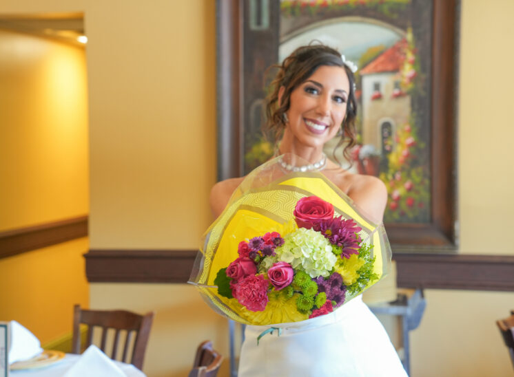 Bride-to-be poses with flowers at Ohio bridal shower